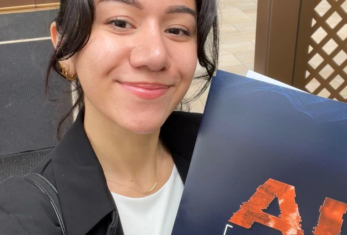 person with an AI conference folder